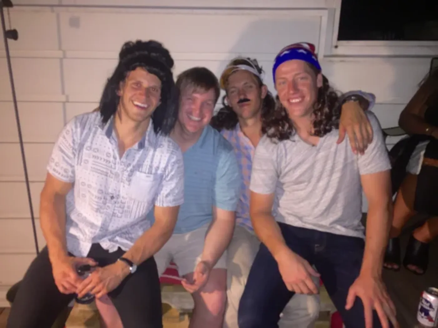 A group of friends crowded together in mullets