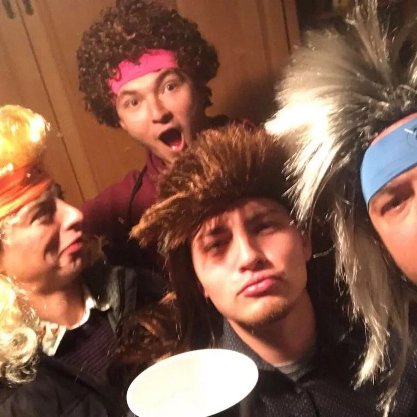 A group in mullets and afros hamming it up for the camera