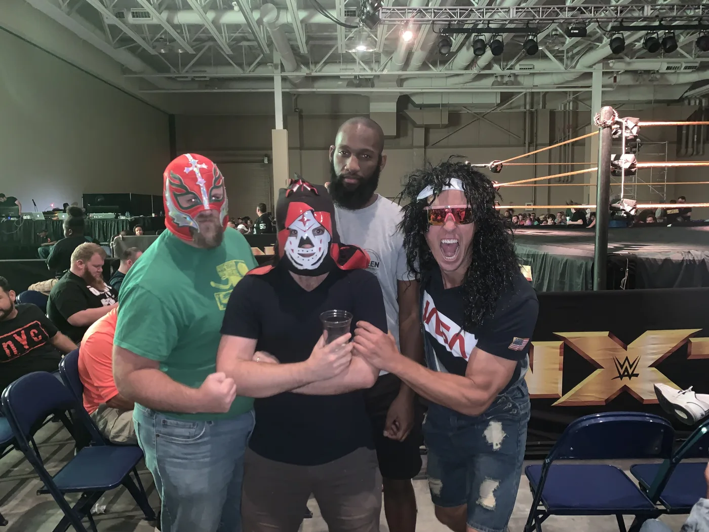 Friends in mullets and luchador masks at a party