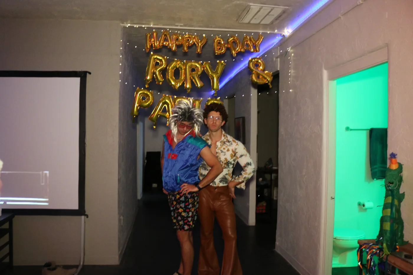 Friends in mullets at a neon lit birthday party